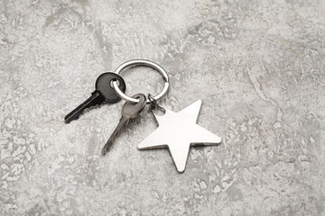 Keys with star shape keychain on grunge background