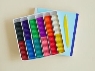 Open box of colored plasticine for children's creativity. Place for your text.