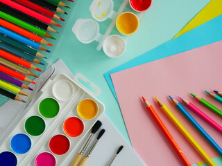 A set for children's creativity. Paints gouache watercolor, colored pencils, colored paper, brushes.