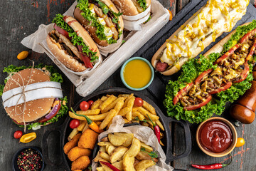 American fast food. Hamburgers, French fries, hot dogs. fast food and unhealthy eating concept. top...
