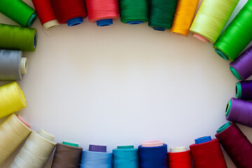 Spools of multicolored threads on a white background. Copy space. Background for design.