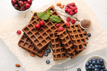 Delicious Chocolate Belgian Waffles with berries on white background