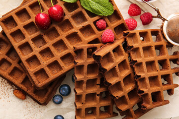 Delicious Chocolate Belgian Waffles with berries on table, closeup