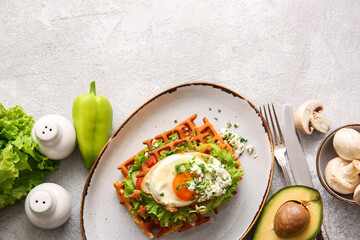 Composition with delicious Belgian waffles and vegetables on light background