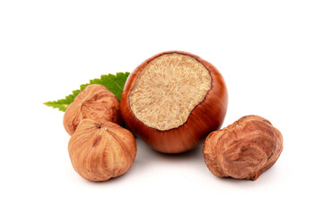 Ripe filbert and green leaves isolated on white