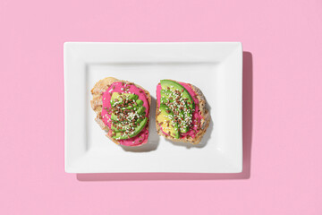 Plate with delicious vegetarian bruschettas on pink background