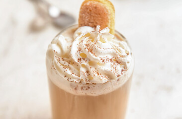 Glass of tasty Tiramisu Latte on light background, closeup