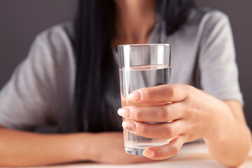 Woman in hand   a glass of water