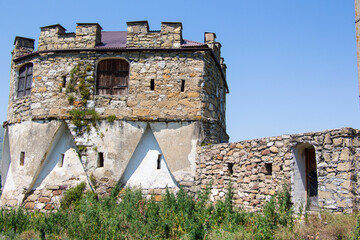 Defensive walls and towers of the castle against the cloudy sky. High quality photo