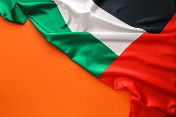 UAE national fabric flag on red background, closeup
