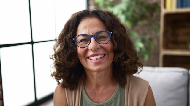 Middle Age Hispanic Woman Speaking To The Camera