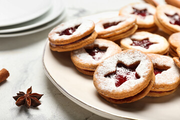 Plate with tasty Linzer cookies on table, closeup