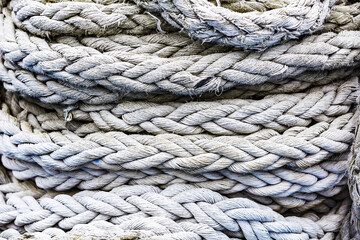 Textured surface of gray mooring rope made from natural fibers