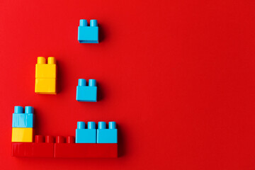 colorful toy blocks, on red background.
