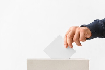 Voting man near ballot box on white background