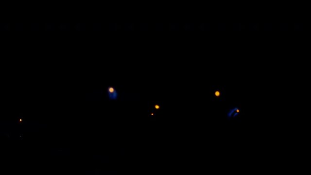 blowing off tea lights isolated on black background moving in wind shot in 4k super slow motion