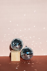 christmas decoration disco ball with sun flares on pink  background