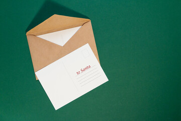 envelope with Christmas letter postcard on green background