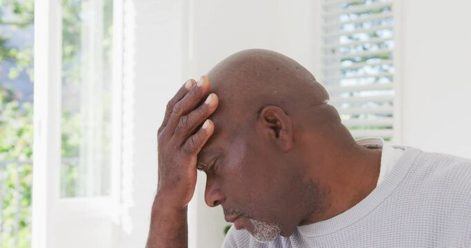Tired african american senior man having headache