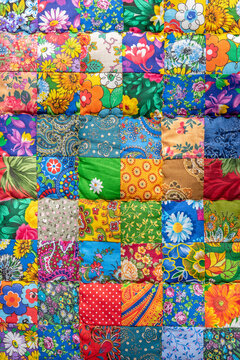Creative traditional handmade patchwork blanket with bright colorful traditional design and flower patterns as vintage artwork