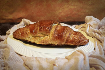 Side view of a croissant on a plate