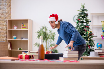 Young male student preparing for exams during new year celebrati