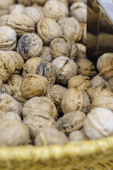 Fototapeta na wymiar Raw shelled walnuts stacked in a basket at the market