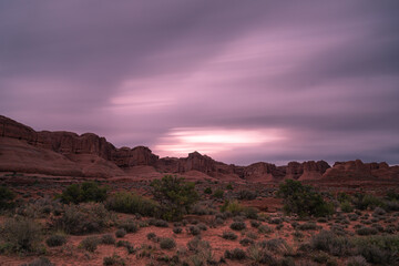 Long exposure sunset sky over desert landscape in Arches National Park, Utah
