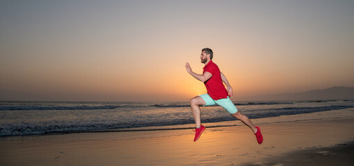 sportsman sprinter running on sunrise summer beach at ocean, copy space, stamina
