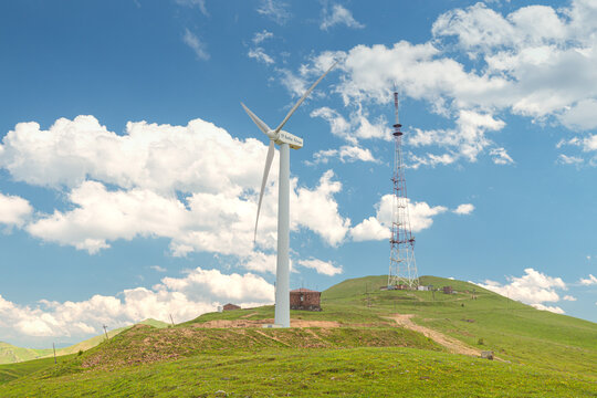 19 May 2021, Pushkin Pass, Armenia: Saba Niroo Iranian company windmill power farm and TV antenna on top of a mountain