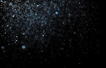 Silver particles reflecting light. Glittering texture against black.