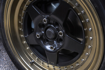 red old racing car on stylish titanium rims