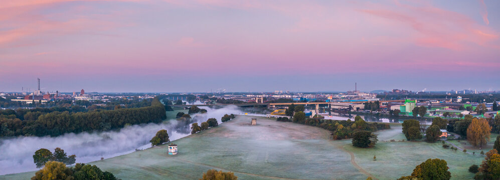 Sunrise and the first rays of sunshine over the fog-covered Ruhr meadows in Duisburg, Germany