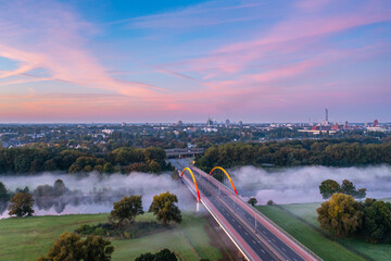 Sunrise and the first rays of sunshine over the fog-covered Ruhr meadows in Duisburg, Germany