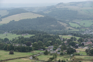 Lovely landscape image of a small village in the Peak District National Park on a misty morning in the English countryside