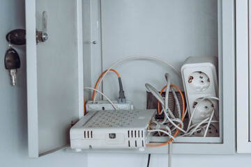 Photo of an internet router, wire and sockets