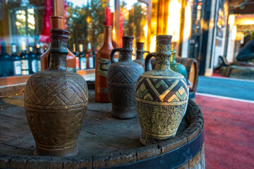 Clay wine jugs stand on a barrel