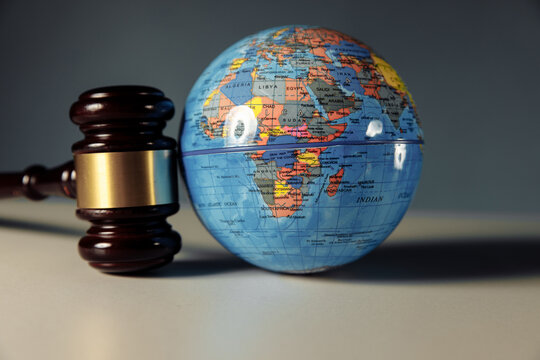 Concept of world justice. Wooden gavel and globe close-up
