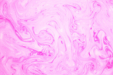Abstract colored marble background, stains of pink paint on the surface of the water. Liquid...