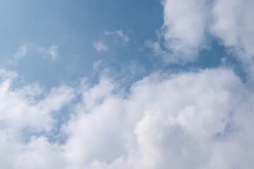 Fototapeta na wymiar Soft fluffy clouds on blue sky. Smooth sunlight aloof