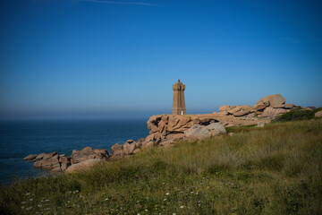 view on the coast of pink granite and the lighthouse of Men Ruz