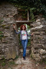 Tourist woman with camera in a ruined fortress