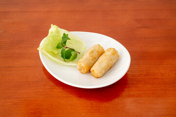 fried crispy vietnamese prawn rolls on white plate