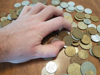 Greed for money, hand grabs gold dollar coins © Petar