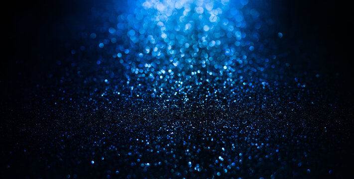 Abstract background of blue glitter lights. De-focused background. Banner size