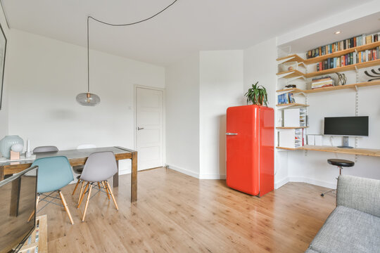 Beautiful furnished living room interior with a red fridge