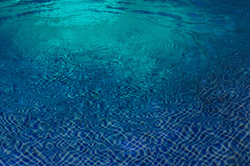 Blue water background with waves and streaks with backlight. Abstract blue background