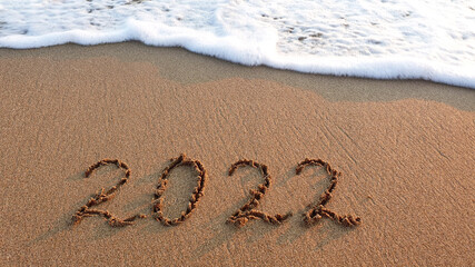 New Year 2022 is coming concept on tropical beach.