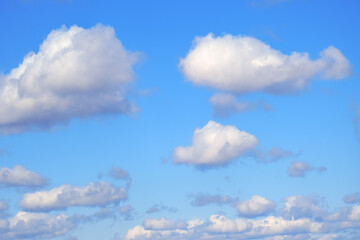 White clouds on a soft day sky, blue background