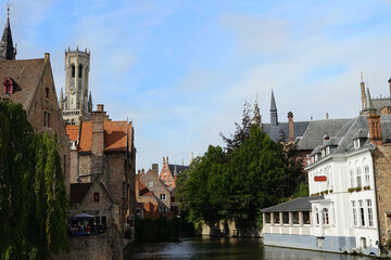 view to the Belfry of Bruges over the watercourse djiver at Rozenhoedkaai, Muelle de las Rosas, Bruges, Flanders, Belgium